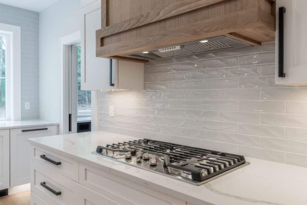 custom kitchen quartz calacatta countertop with white shaker cabinets