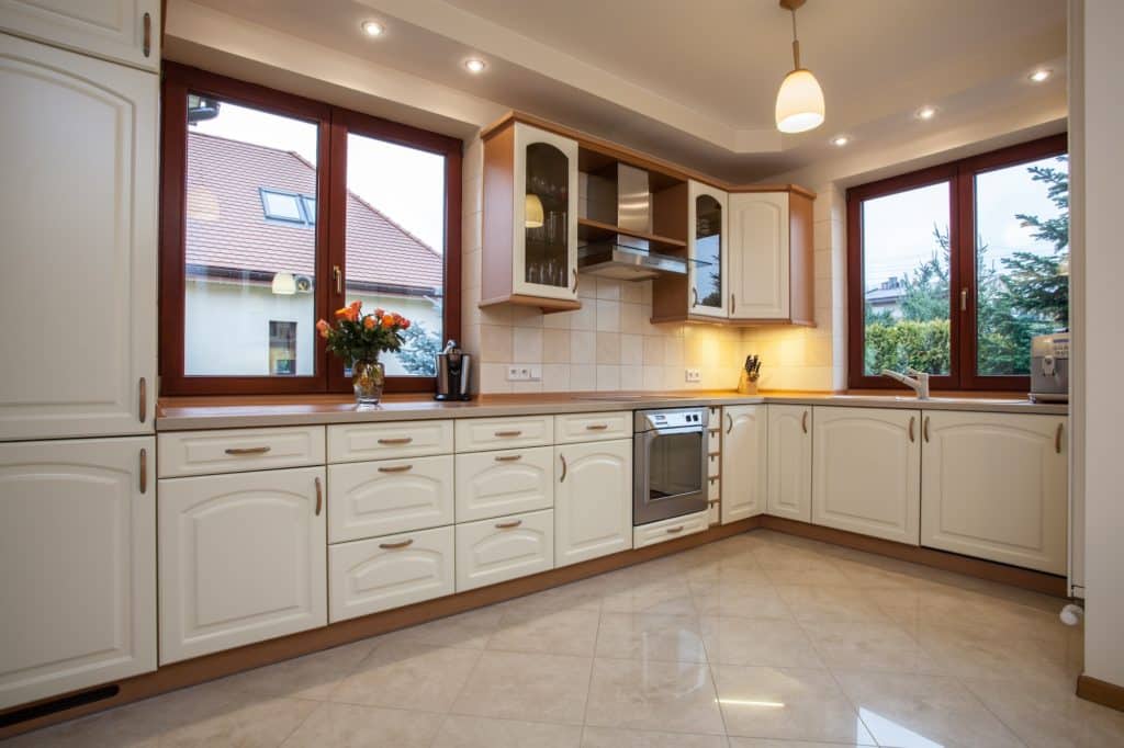 Kitchen with white traditional raised-panel kitchen cabinets