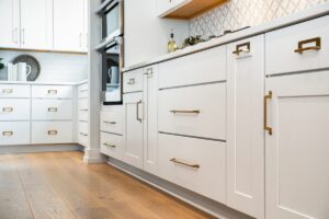 Dark island cabinets with white perimeter kitchen cabinetry showing premium custom craftsmanship