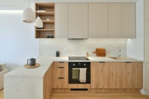 Large white and natural oak farmhouse kitchen with high ceilings, chandelier pendants, and custom cabinetry