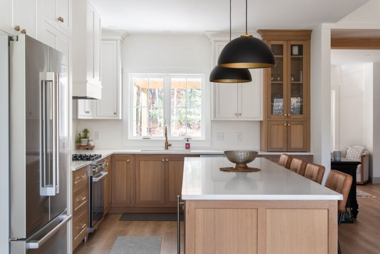 Two-tone Maine kitchen with white painted shaker upper cabinet doors and natural white oak lower cabinet doors by Maine Cabinet Company